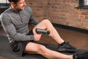 A-man-using-the-Core-Balance-massage-gun-on-the-calves-1024x683